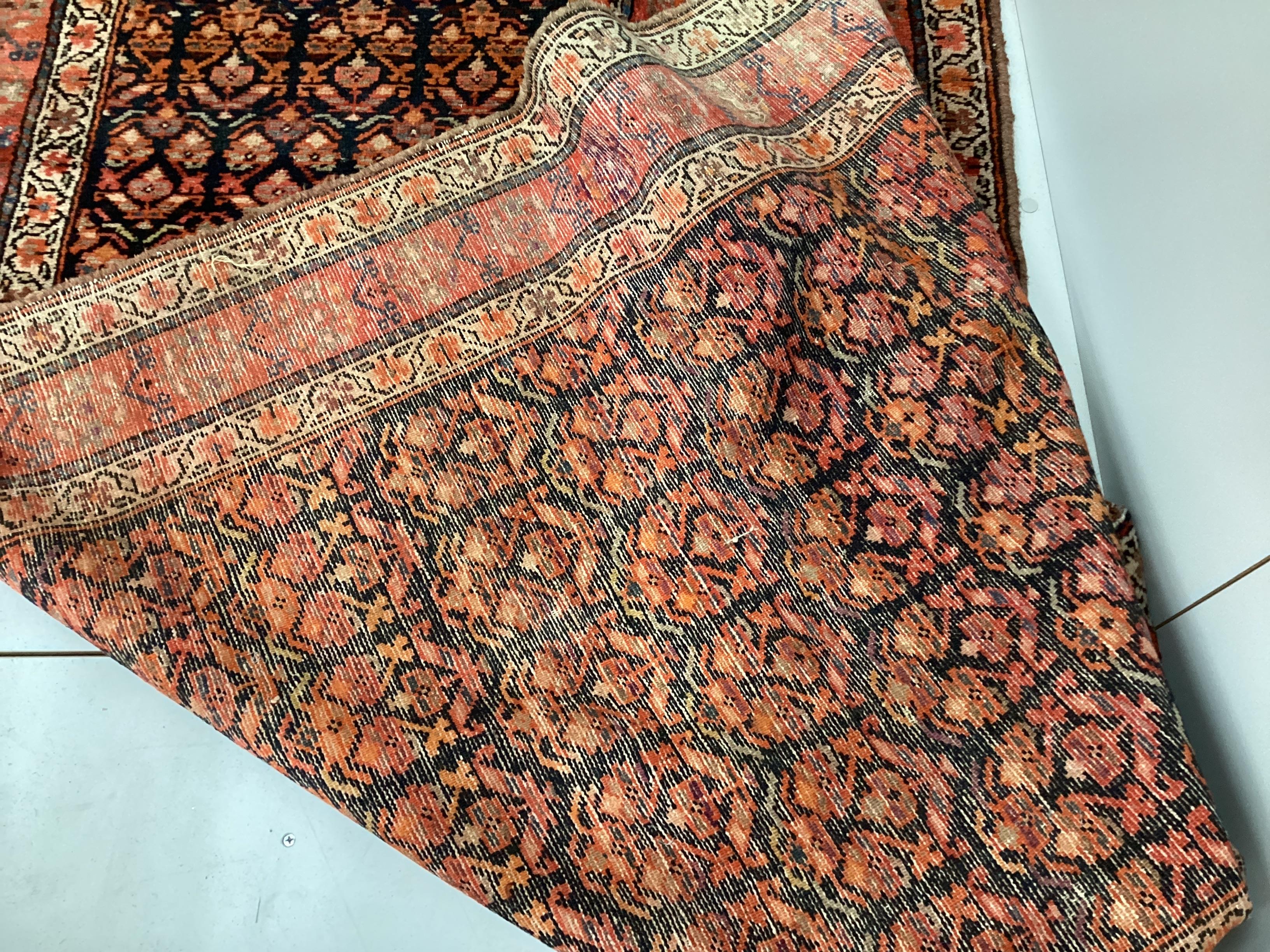 An Afshar blue ground runner woven with rows of floral devices, 354cm x 107cm